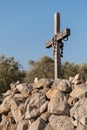 Rosary hanging on a small wooden cross on a stone wall Royalty Free Stock Photo