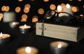 Rosary on holy bible with candlelights and bokeh lights background Royalty Free Stock Photo