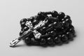 Rosary on a monophonic background. Black and white photography.