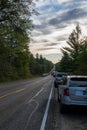 Roscommon MI - September 18, 2021:Vehicles parks on crowded rural road