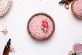 Rose bath salt with flowers and natural oil bottles on white background Royalty Free Stock Photo