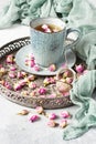 Rose buds tea, tea cup, strainer  with rosebuds on  vintage tray Royalty Free Stock Photo