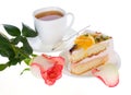 Rose cake with fruits and cup of tea