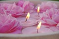 Rose candles.Pink burning candles and pink roses in water.Aromatherapy and spa.Candle flame. Candles background. Royalty Free Stock Photo