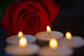 Rose with candles, red background Royalty Free Stock Photo