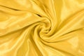 Drapery of golden satin. Luxury smooth yellow golden silk for background. Fabric rose on the drapery Royalty Free Stock Photo