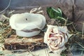 Rose, dry hay and a candle on a table Royalty Free Stock Photo