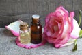 Rose essential oil in a glass bottle on old wooden table.Spa, skin care or aromatherapy concept.Organic cosmetics. Royalty Free Stock Photo