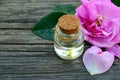 Rose essential oil in a glass bottle on old wooden table.Spa, skin care or aromatherapy concept.Organic cosmetics. Royalty Free Stock Photo