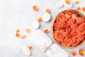 Rose flower in bowl, towel and candles on stone table top view. Spa, aromatherapy, wellness, beauty background.