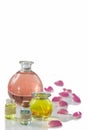 Rose flower petals with aromatherapy essential oil glass bottle over white , background, copy-space Royalty Free Stock Photo