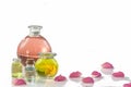 Rose flower petals with aromatherapy essential oil glass bottle over white , background, copy-space Royalty Free Stock Photo