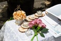 Rose flowers, candles, wood pieces and other small decoration on reception table for wedding party in catholic church