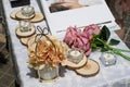 Rose flowers, candles, wood pieces and other small decoration on reception table for wedding party in catholic church