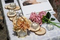 Rose flowers, candles, wood pieces and other small decoration on reception table for wedding party in catholic church Royalty Free Stock Photo