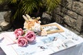 Rose flowers, candles, wood pieces and other small decoration on reception table for wedding party in catholic church Royalty Free Stock Photo