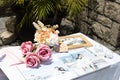 Rose flowers, candles, wood pieces and other small decoration on reception table for wedding party in catholic church