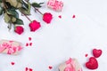 Rose flowers with presents on table from above with copy space, flat lay