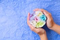 Rose flowers shaped scented soap petals in transperent round box on young girl`s hands Royalty Free Stock Photo