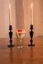 Rose in a glass and candles