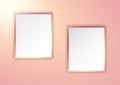 Rose gold picture frames on spotlit wall Royalty Free Stock Photo