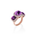 Rose gold ring with purple saphires and multiple diamonds, cushion cut gems Royalty Free Stock Photo