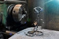 Rose hand forged. This handmade rose is forged from metal against the background of a lathe chuck Royalty Free Stock Photo