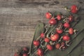 Rose hip berries, sweet briar fruits, gloves on wooden board Royalty Free Stock Photo