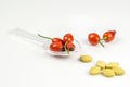 Rose hip on a medicine spoon with vitamin pills Royalty Free Stock Photo