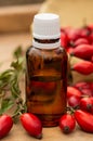 Rose-hips and rose hip seed oil on the wooden table. Rose hip  commonly known as rose hip Rosa canina. Royalty Free Stock Photo