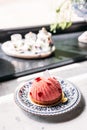 Rose and Lychee Mousses Cake decorated with rose petals in blue and white porcelain plate on marble top table Royalty Free Stock Photo