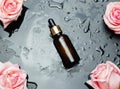 rose oil bottle and rose flowers on a black wet background Royalty Free Stock Photo