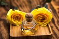 Rose oil in a glass bottle and pink flowers Royalty Free Stock Photo