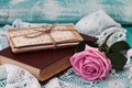 Rose and old letters are near book in a vintage style. Royalty Free Stock Photo