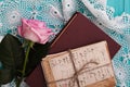 Rose and old letters are near book in a vintage style. Royalty Free Stock Photo