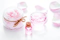 Rose organic cosmetics with salt, cream and oil on white table b