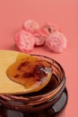 Rose petal jam in a glass jar on pink background, copy space Royalty Free Stock Photo