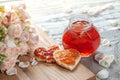 Rose petal jam and heart shaped sandwich with marmalade rose flower on table Royalty Free Stock Photo