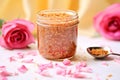 rose petal scrub in a mason jar, fresh roses in the background Royalty Free Stock Photo