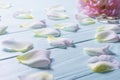 Rose petals on a blue wooden background.