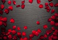 Rose petals border background on a black slate stone plate Royalty Free Stock Photo