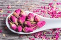 Rose petals and dried flowers in ceramic spoon Royalty Free Stock Photo