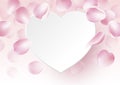 Rose petals falling with blank paper heart on pink background Royalty Free Stock Photo