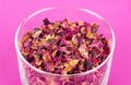 Rose petals in a glass bowl over pink Royalty Free Stock Photo