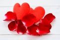 Rose petals and heart on white wooden background - flower red rose petals for valentine day concept Royalty Free Stock Photo