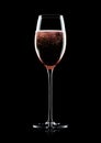 Rose pink champagne glass with bubbles on black Royalty Free Stock Photo