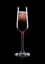 Rose pink champagne glass with bubbles on black Royalty Free Stock Photo