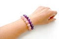 Rose quartz and amethyst bracelets on a woman wrist. Royalty Free Stock Photo