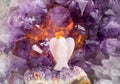 Rose quartz angel shape against amethyst geode indoors, studio shot. Royalty Free Stock Photo