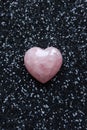 rose quartz heart on black glitter background, valentine\'s day concept. Royalty Free Stock Photo